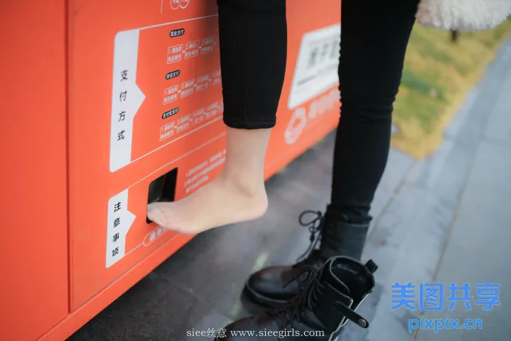 有人站在一个红色的盒子上，双脚伸出来