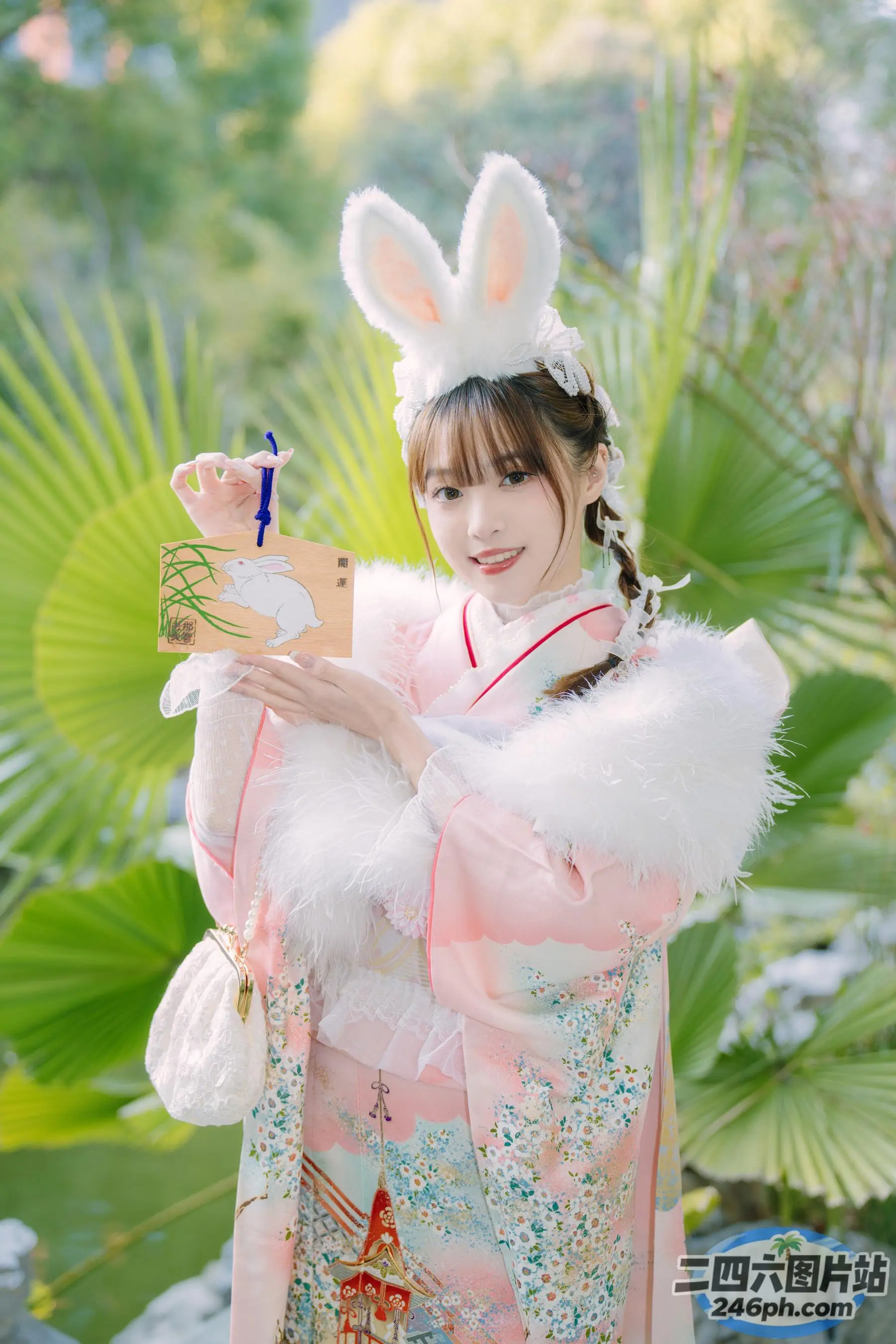 有一个穿着粉色和白色服装的女人，手里拿着一个玩具