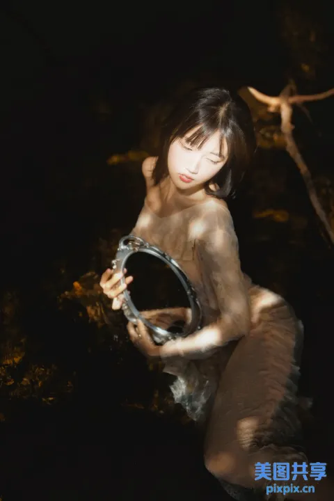 有一个女人，手里拿着一面镜子