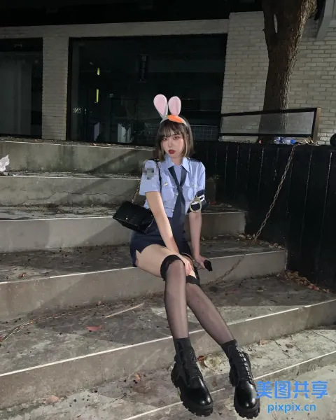 台阶上坐着一个戴着兔子耳朵帽的女人