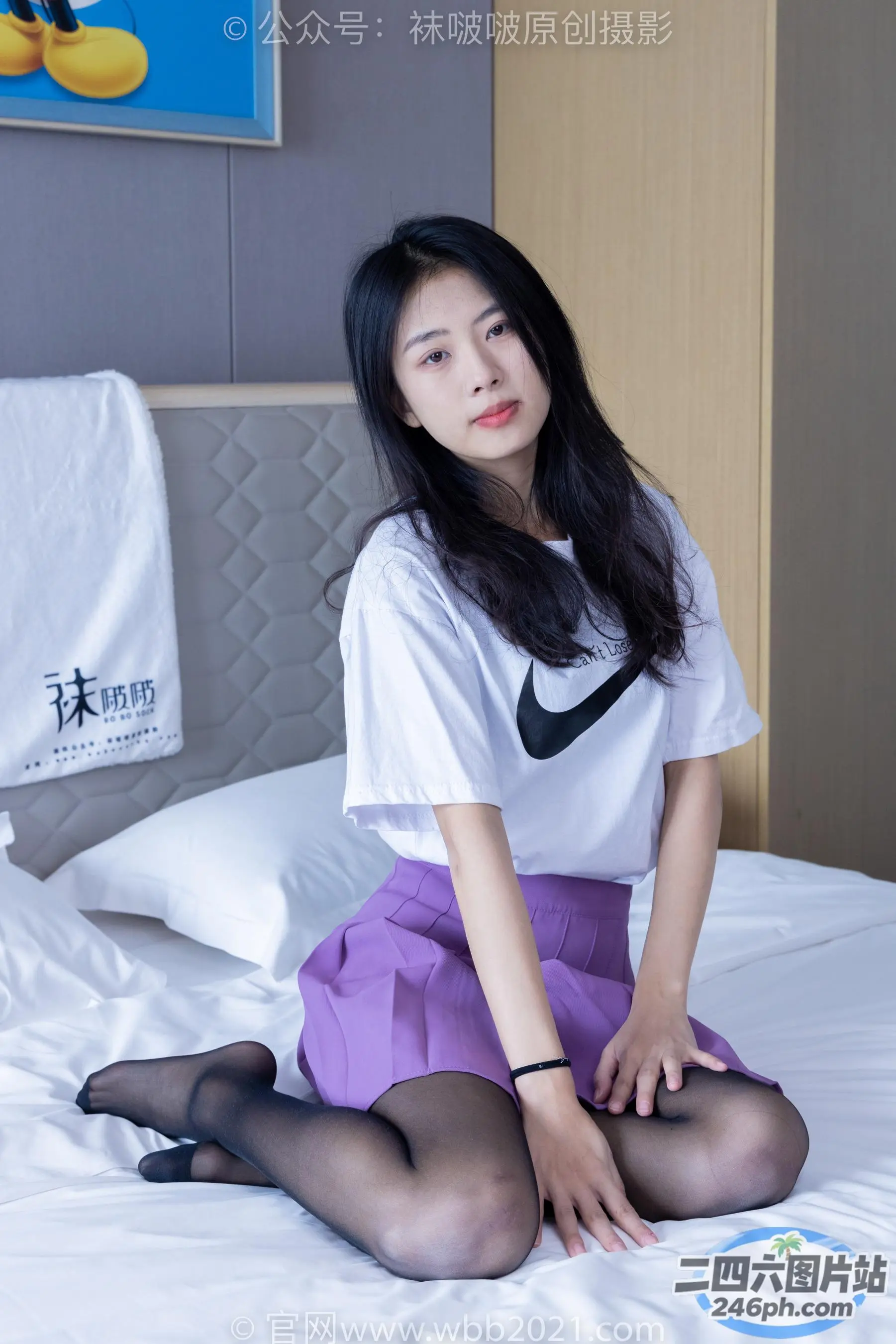 穿着白衬衫和紫色裙子坐在床上的阿拉夫德亚洲妇女