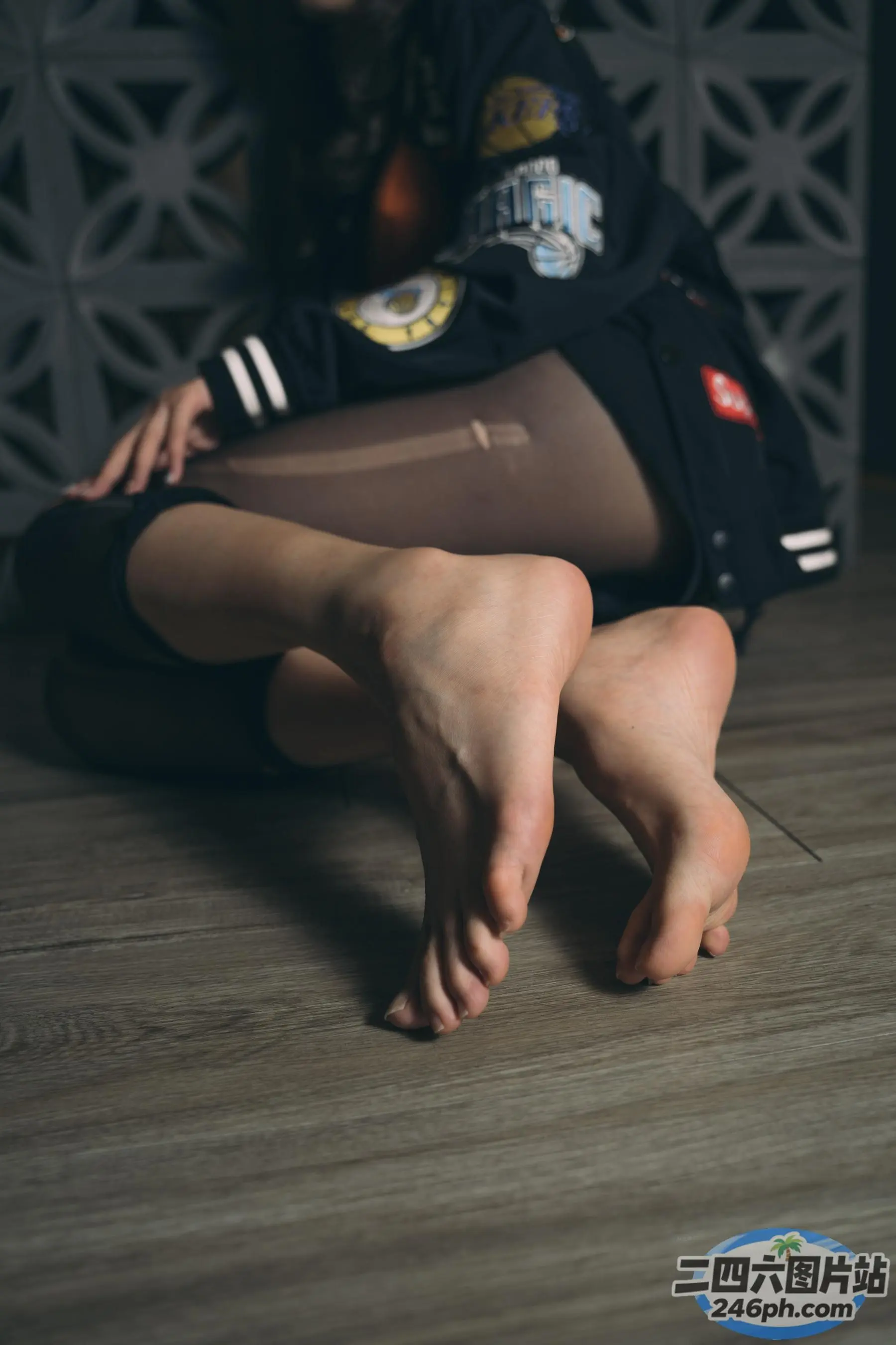 有一个女人坐在地板上，双叉