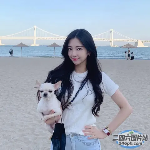 阿拉费德女子在桥附近的海滩上抱着一只小狗