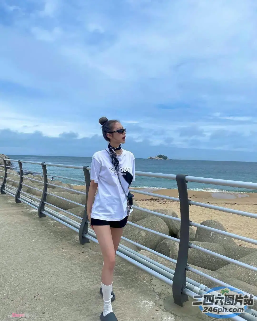 海边的木板路上走着一个女人