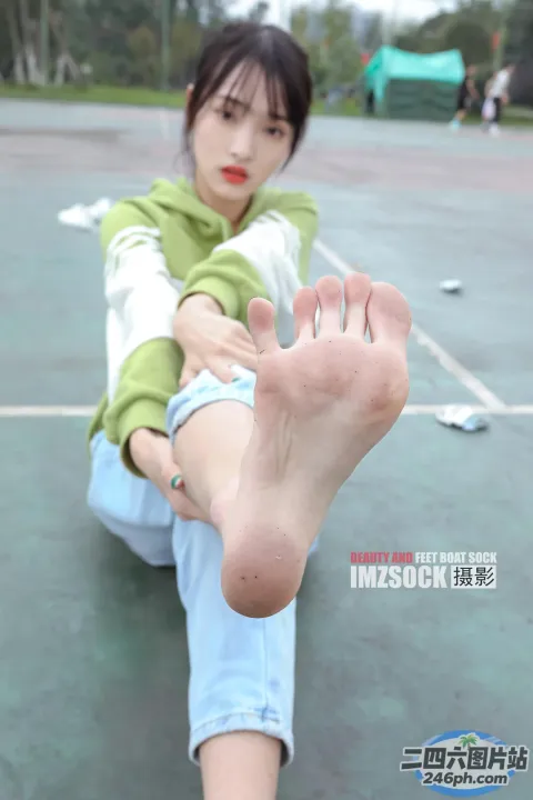 有一个女人坐在地上，双脚抬起