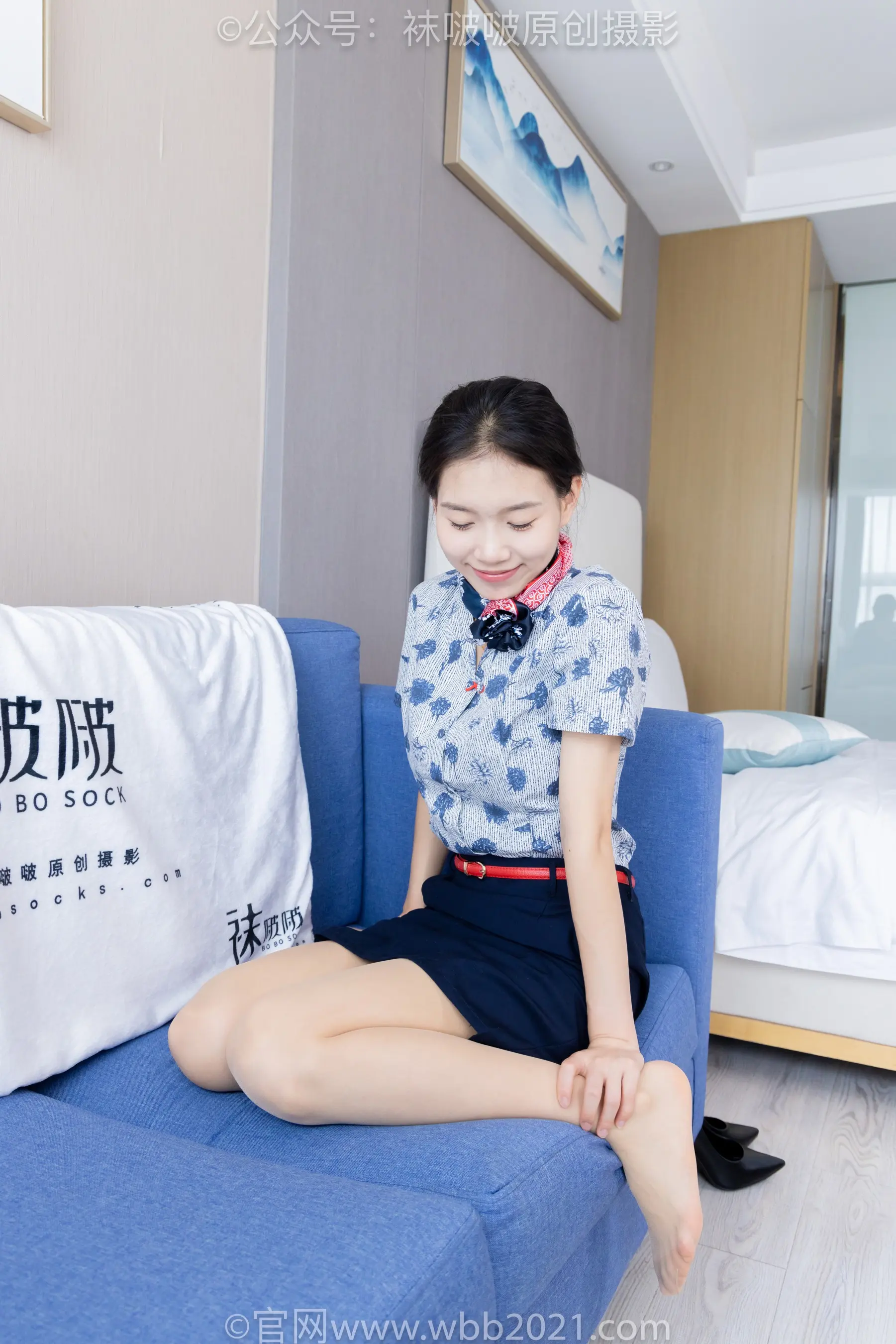 坐在酒店房间蓝色沙发上的 arafed 女人