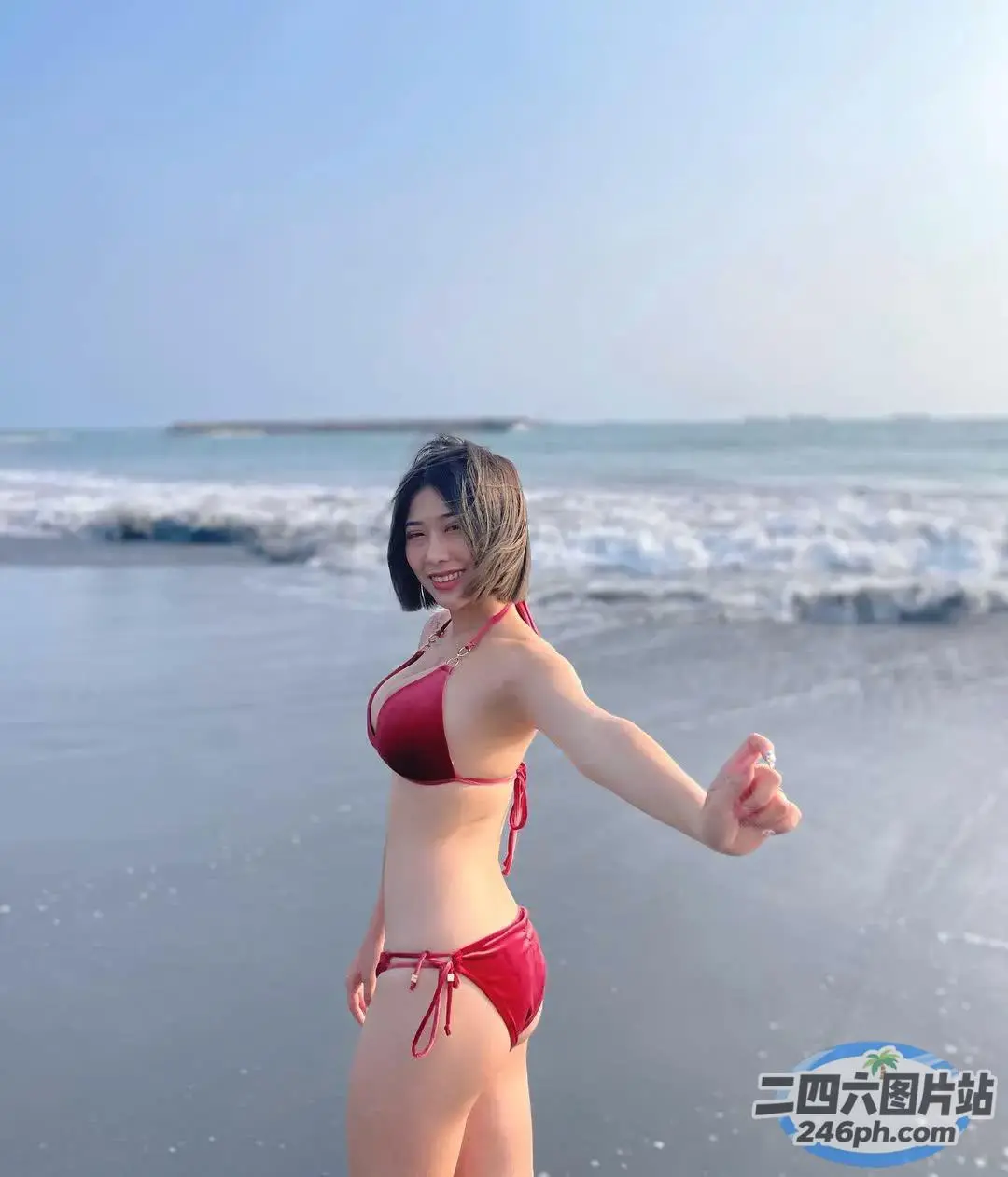 海滩上站着一个穿着红色比基尼的女人