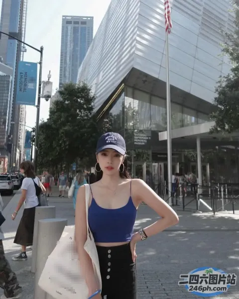 身穿蓝色上衣和黑色裤子的 Araffe 女子站在人行道上
