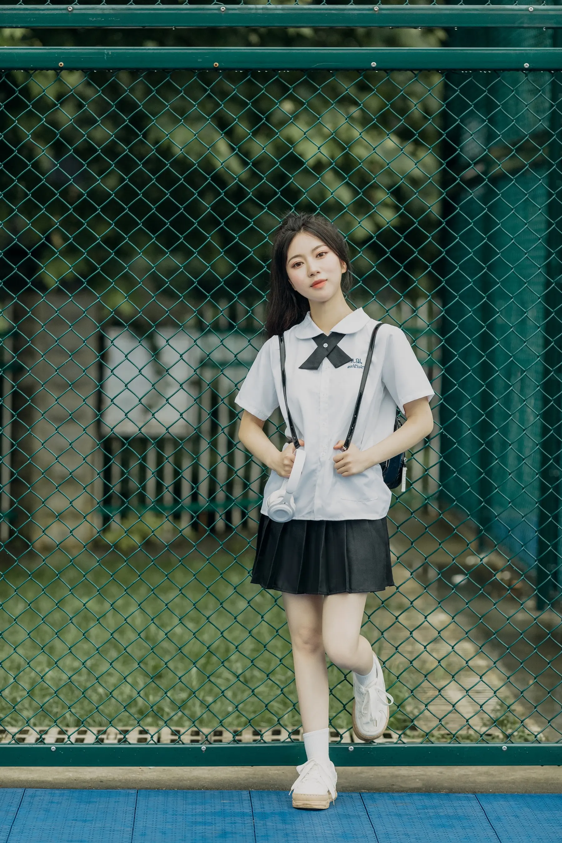 身穿校服的 arafed 亚裔女子合影留念