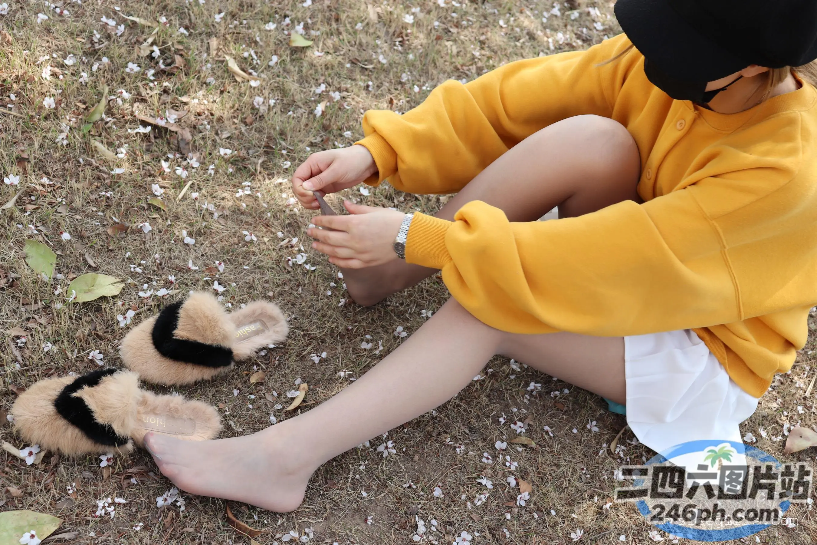有一个小男孩坐在地上和两个小毛绒玩具玩耍