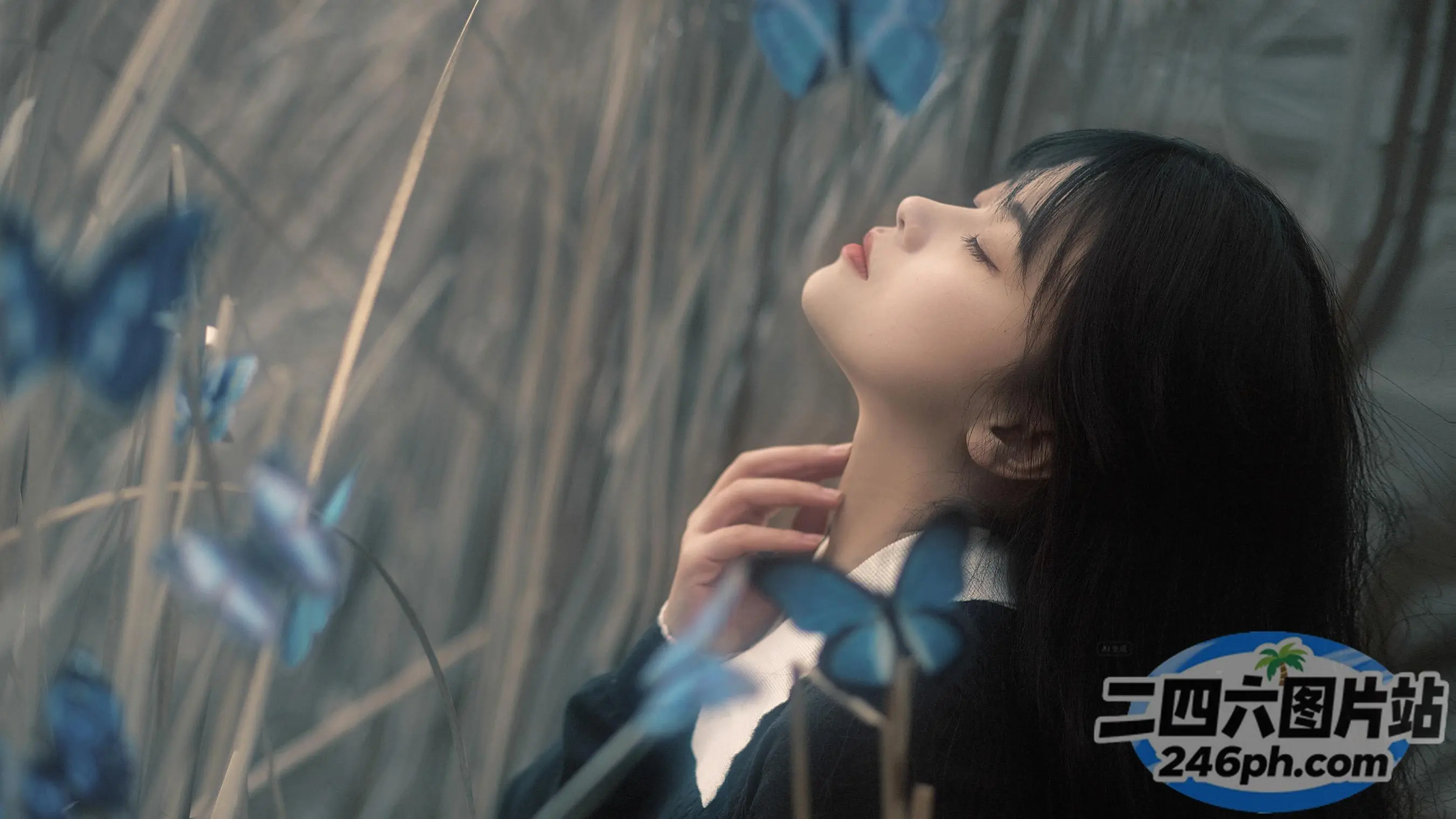 有一个女人站在草地上，开着蓝色的花朵
