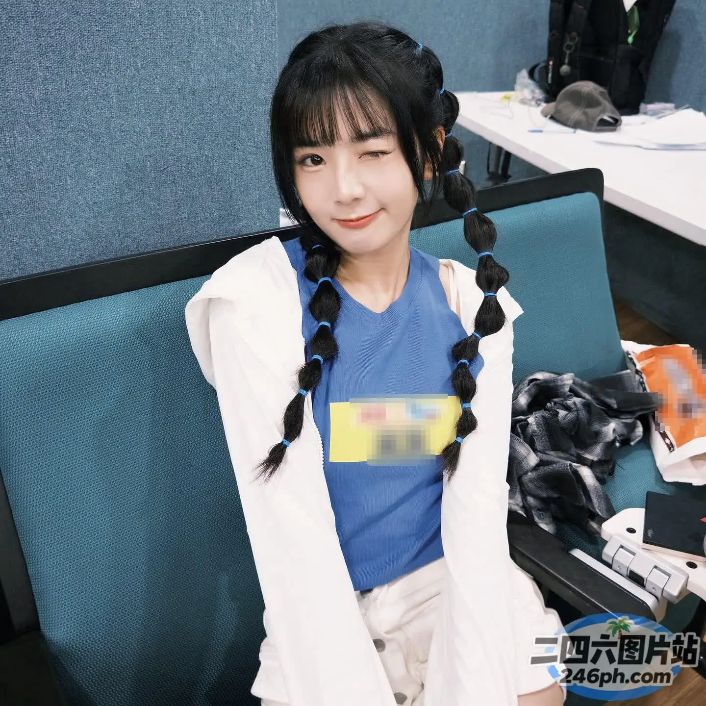 有一位女士坐在蓝色的椅子上，穿着蓝色的衬衫