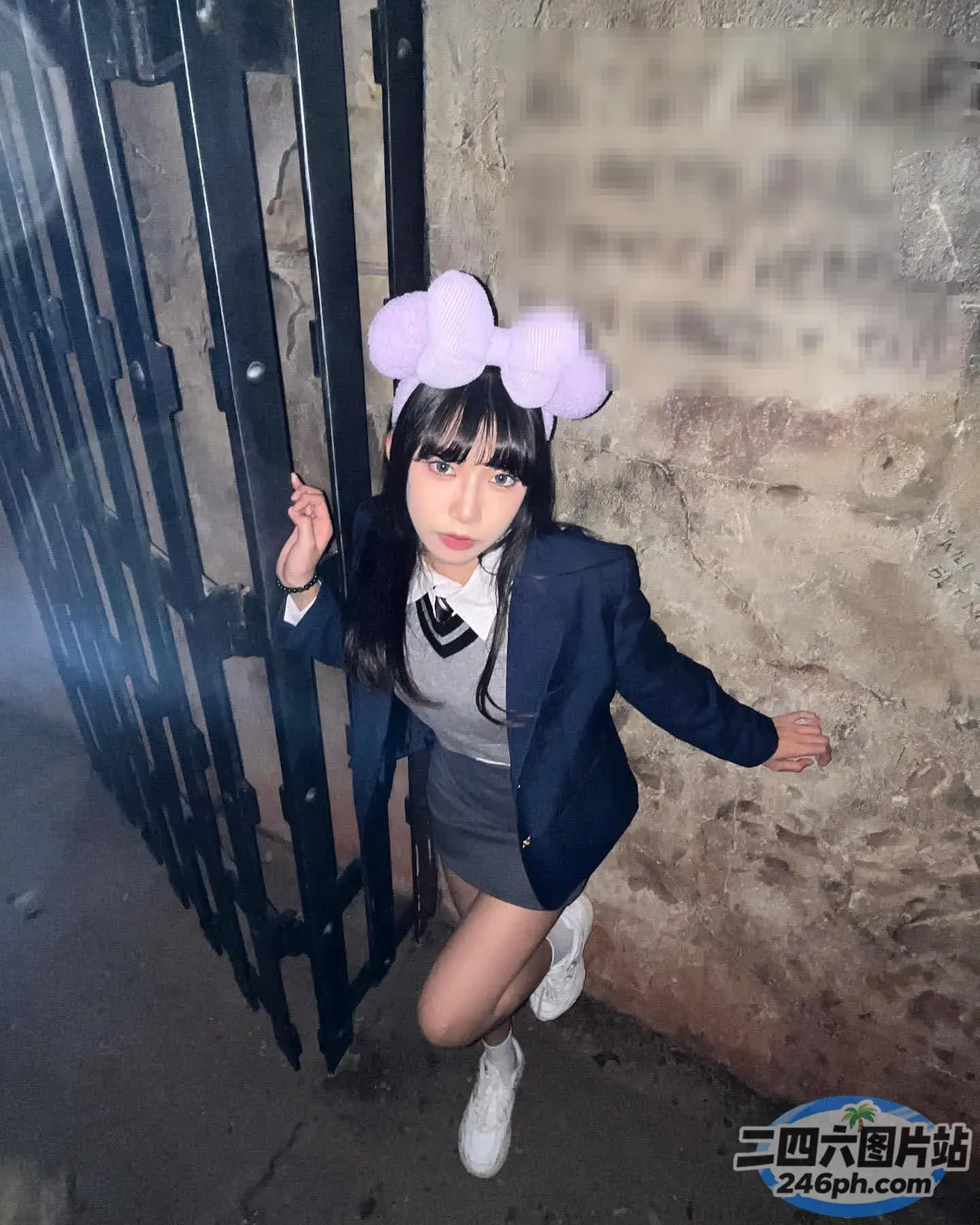 有一位西装革履、打着领结的女子摆姿势拍照