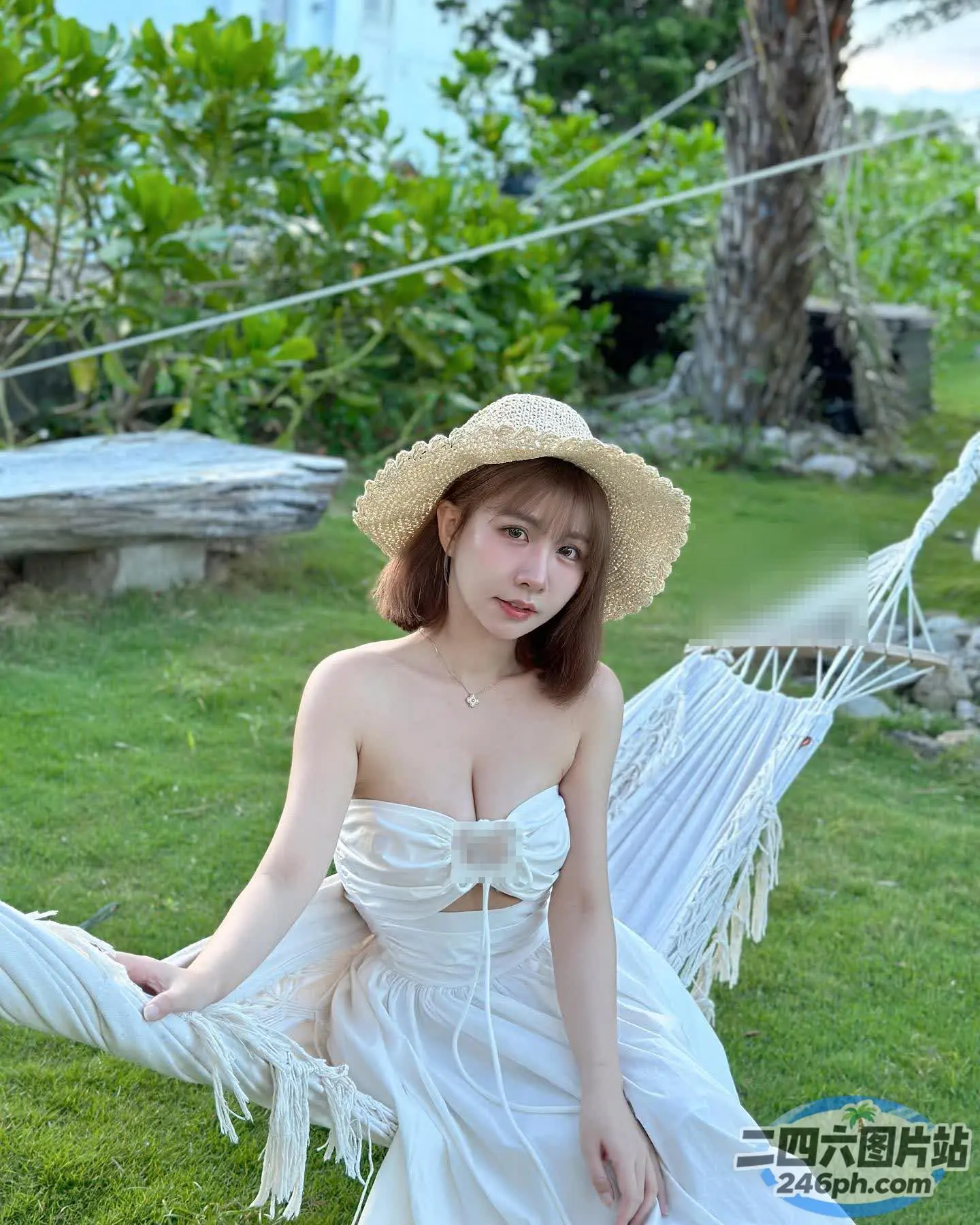 阿拉伯裔亚洲女性，身穿白色连衣裙，戴着草帽，坐在吊床上