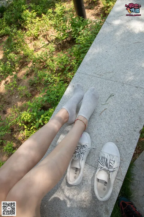 有人坐在长凳上，脚抬起，穿着鞋子