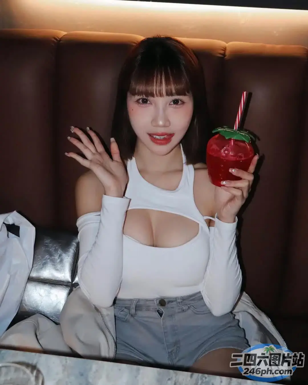 Araffe 亚洲女性 白上衣 手里拿着草莓饮料