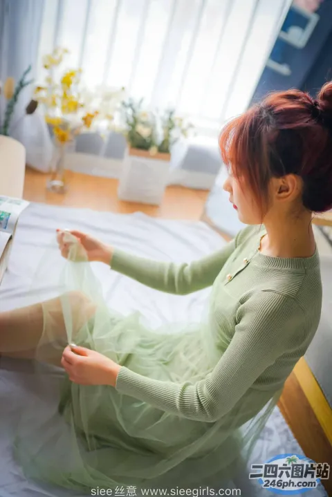 阿拉伯女 （Araffe Woman） 穿着绿色连衣裙坐在床上
