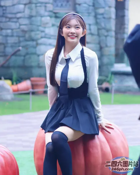 有一个穿着校服的女人坐在南瓜上