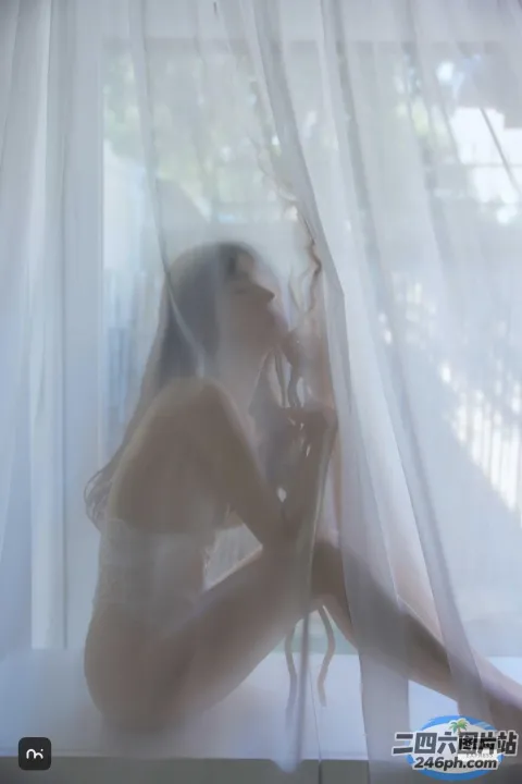有一个女人坐在窗户上，窗帘拉着
