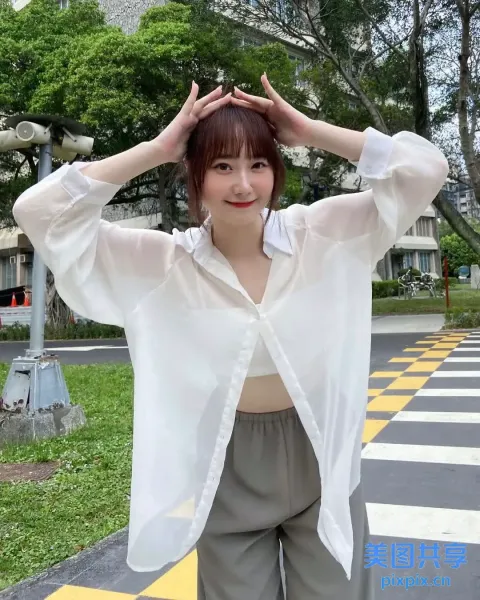 有一个女人站在街上，双手抱头