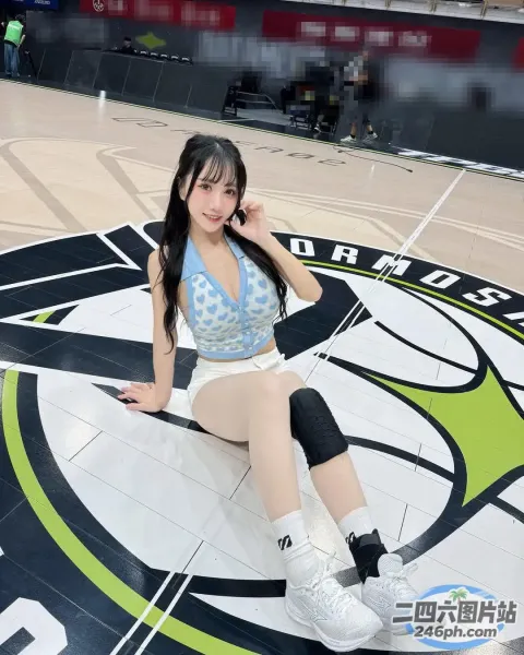 阿拉夫德亚洲女子拿着篮球坐在篮球场上