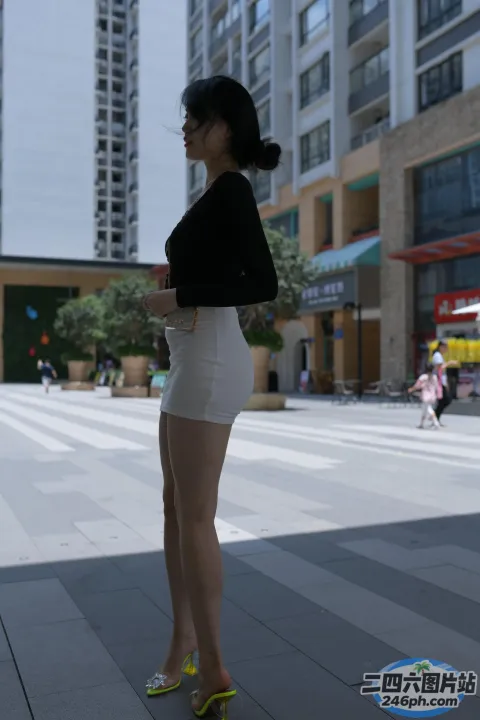 城市的人行道上站着一个女人