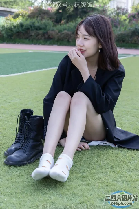 拿着一双鞋坐在草地上的阿拉夫德女人