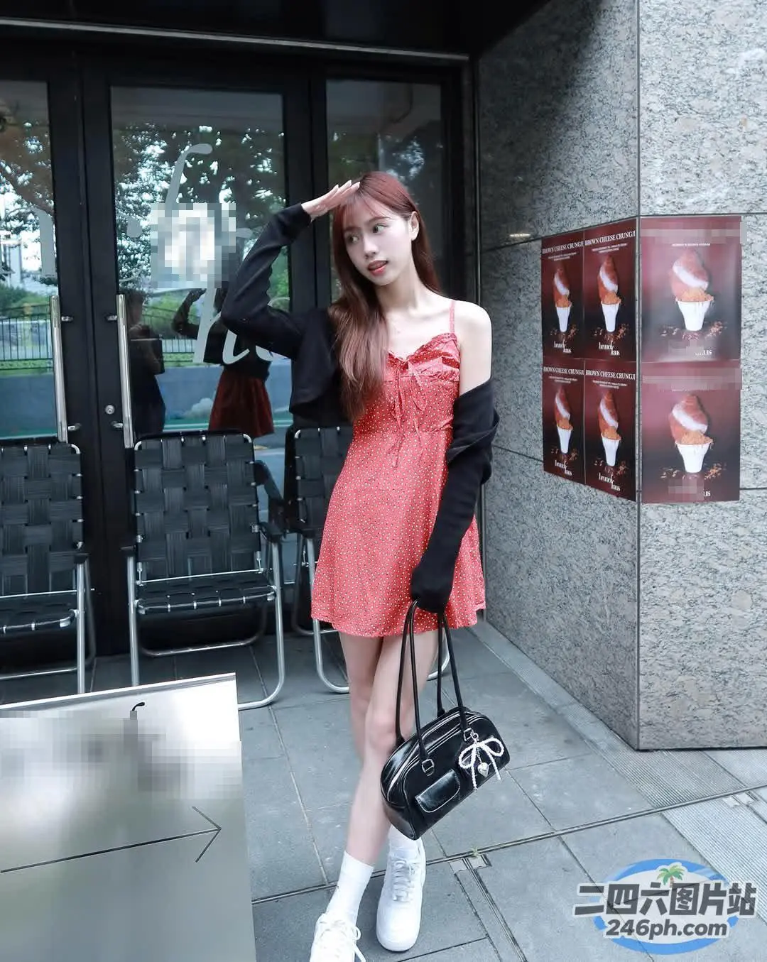 有个女人拿着钱包站在一栋楼外