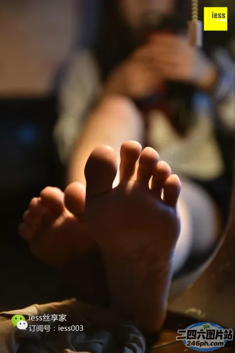 有人坐在床上，双脚抬起