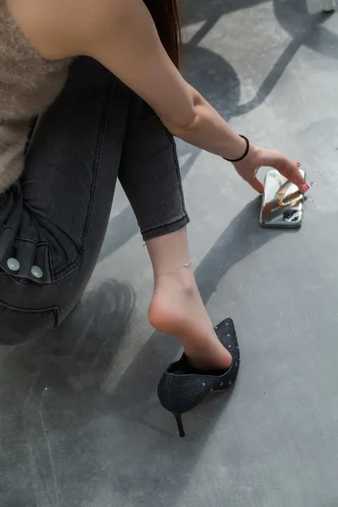 穿着鞋子坐在地上的阿拉菲德女人