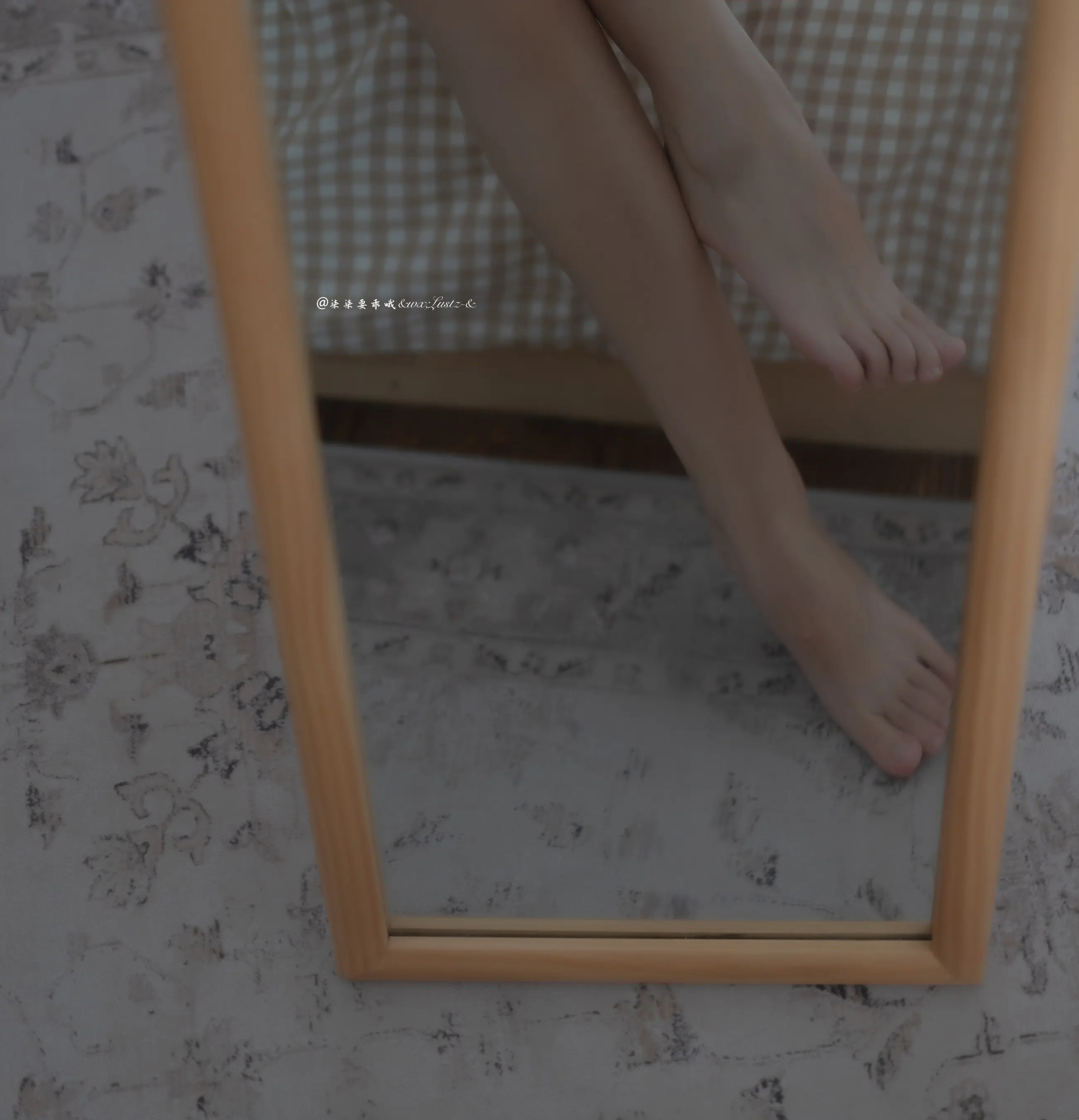床上的镜子里有一个女人的腿