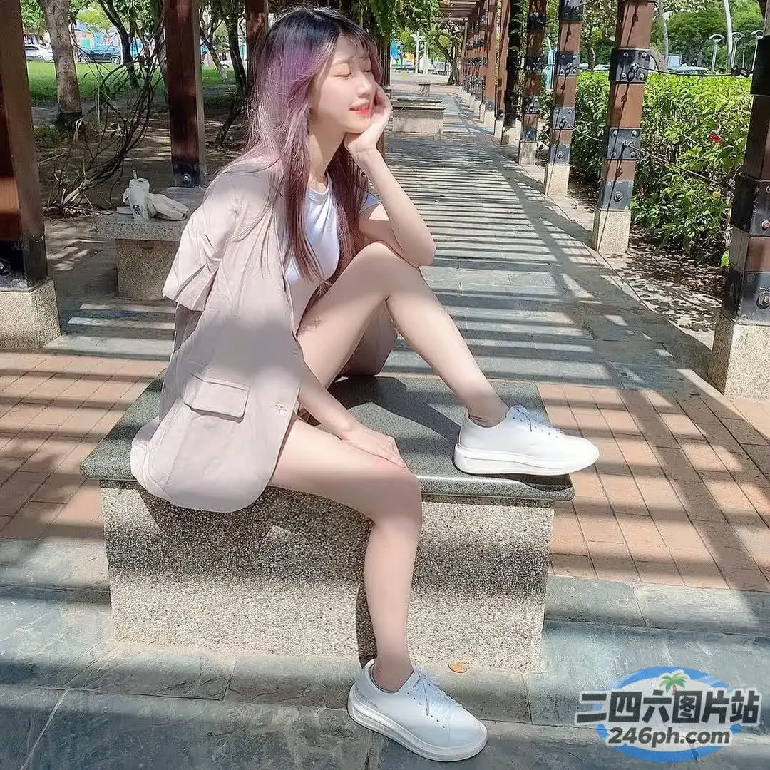 阿拉菲女人坐在石阶上，一头粉红色的头发