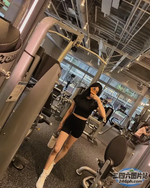 有一个女人站在健身房里