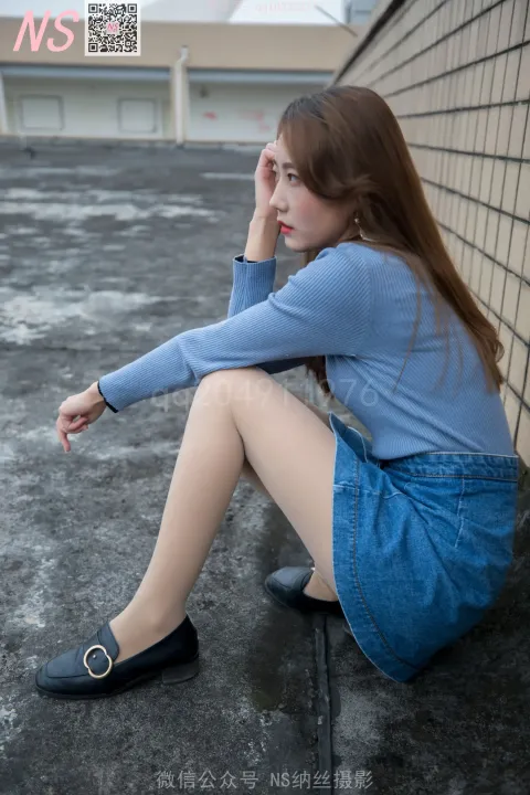 阿拉夫德女人坐在地上，双腿交叉