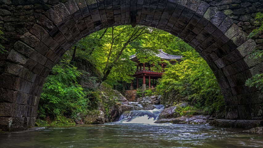 溪流上的 Arafed 拱门，背景是宝塔