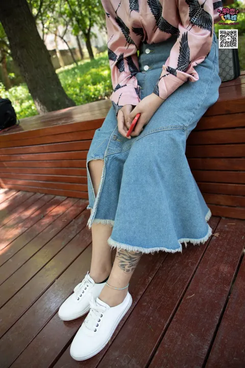有个女人拿着一把剪刀坐在长凳上