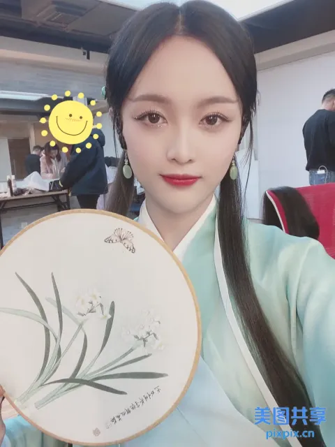 身穿蓝色连衣裙的阿拉菲女人拿着一个带有花朵图案的白色盘子