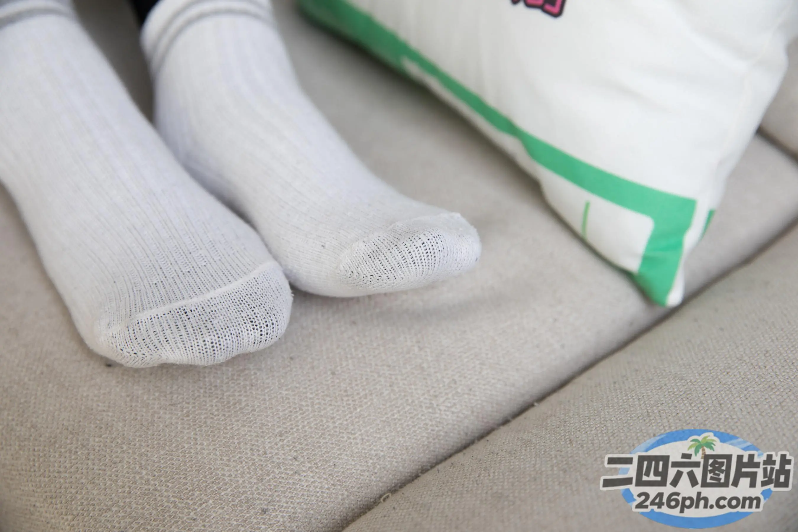 沙发上放着两双袜子，旁边是一个枕头