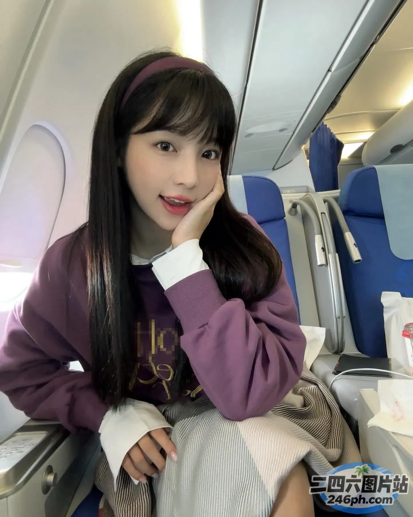arafed 亚洲妇女坐在飞机上，手放在下巴上