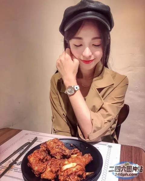 女人坐在桌子旁，手里拿着一盘食物和一块手表