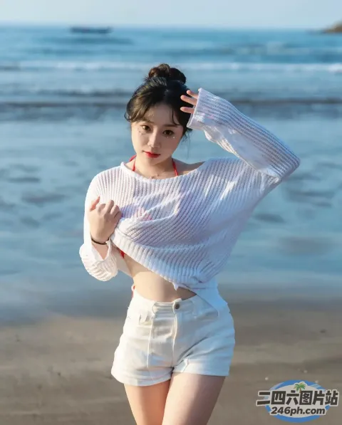 身穿白衬衫和短裤的阿拉伯裔女子在靠近水边的海滩上