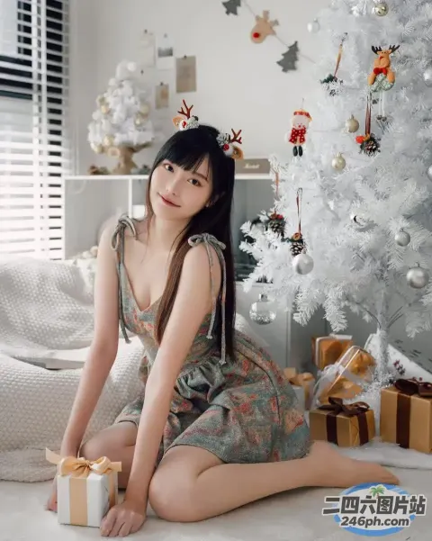 阿拉菲女人坐在圣诞树前拿着礼物