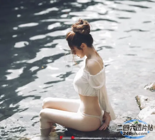 There is a woman on a rock in the water （有个女人坐在水中的一块岩石上）