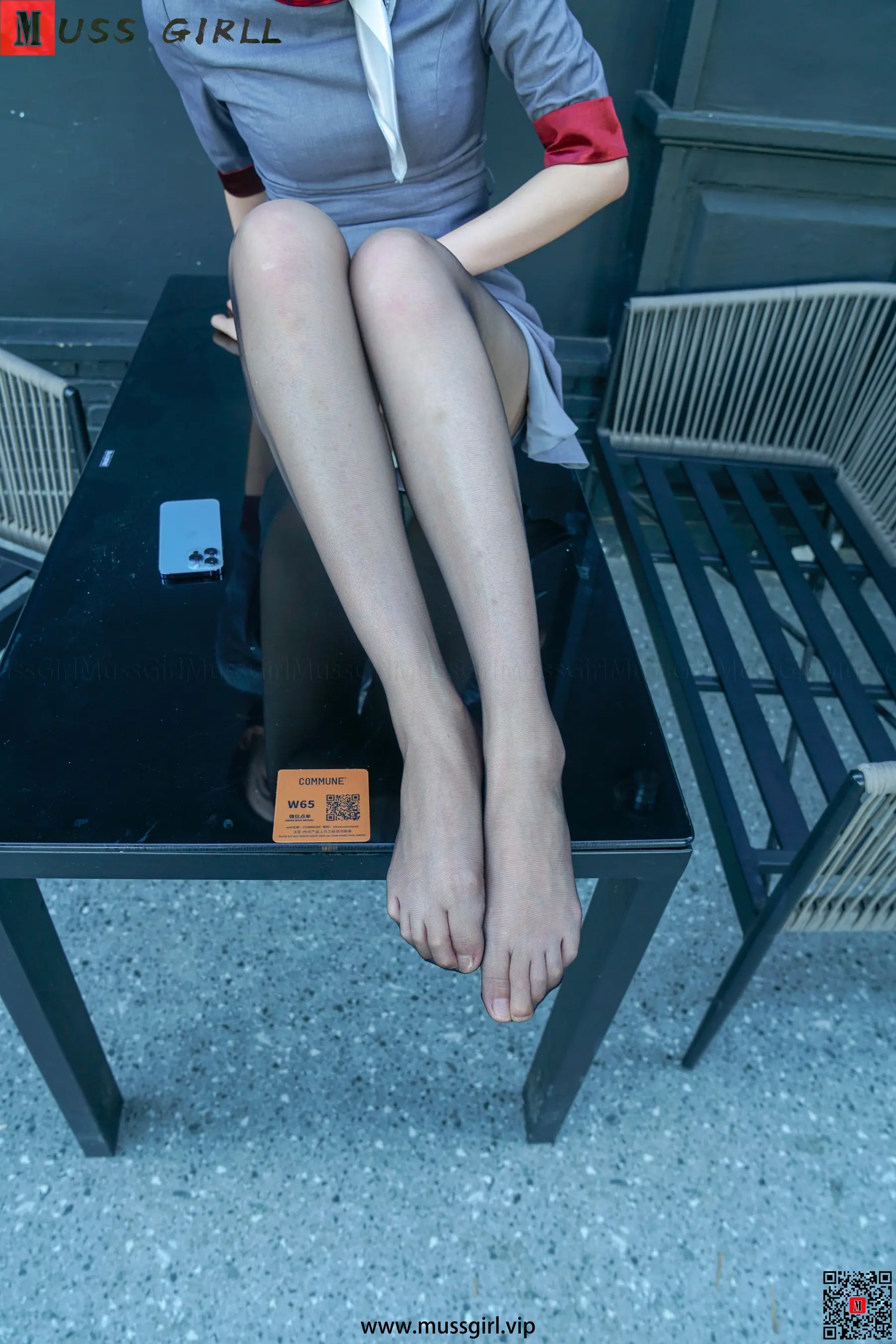 有个女人坐在椅子上，双腿交叉