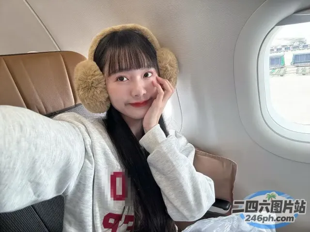 戴着毛茸茸的帽子坐在飞机上的 arafed 女人
