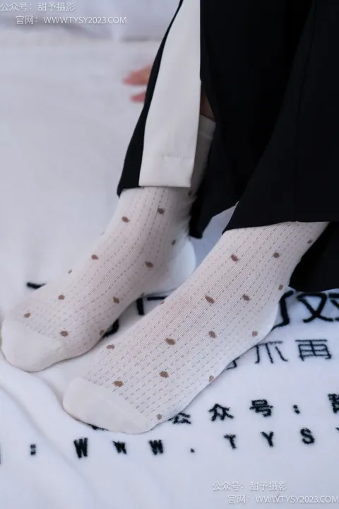 一个穿着白色袜子和黑色裤子的人的特写