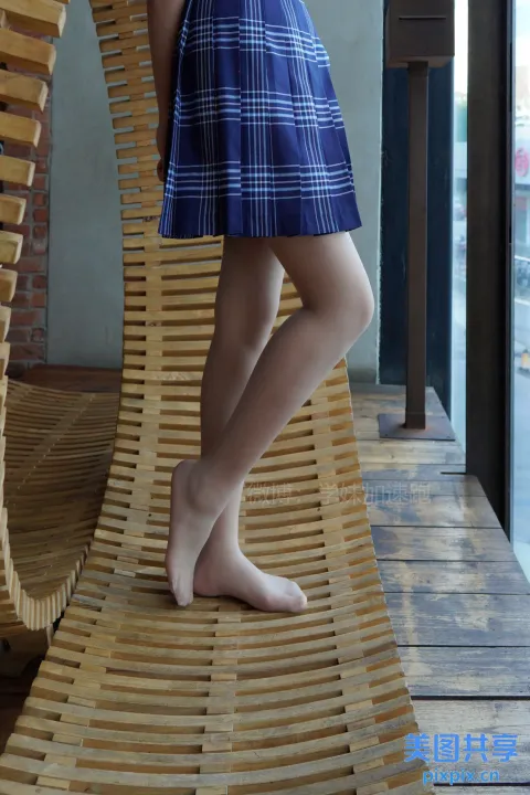 穿着蓝色裙子的阿拉夫德女人站在木凳上