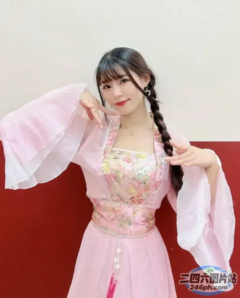 身穿粉红色连衣裙的 Araffe 女子合影留念