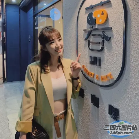 身穿棕褐色夹克和白色裙子的女子站在标牌前
