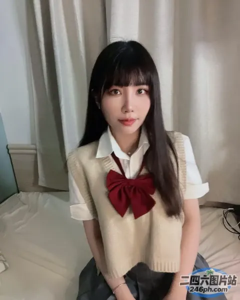 阿拉菲德亚洲女子坐在床上，系着红色领结
